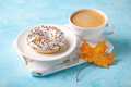 Fresh donut with cup of coffee and fall maple leaf. Autumn concept - PhotoDune Item for Sale