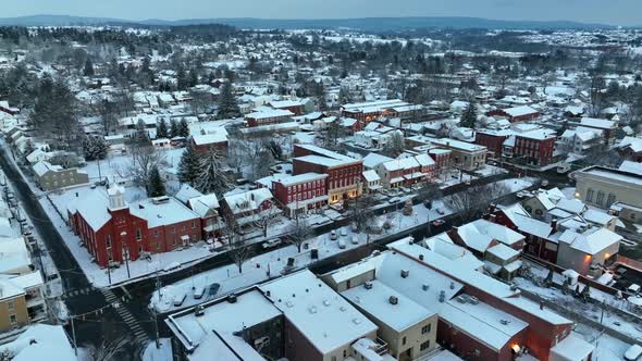 Christmas snow in small town in USA. Church and homes in early morning shot. Snowflakes and flurries