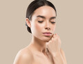 Asia woman beauty face body portrait touching her face healthy skin. Color background. Brown - PhotoDune Item for Sale