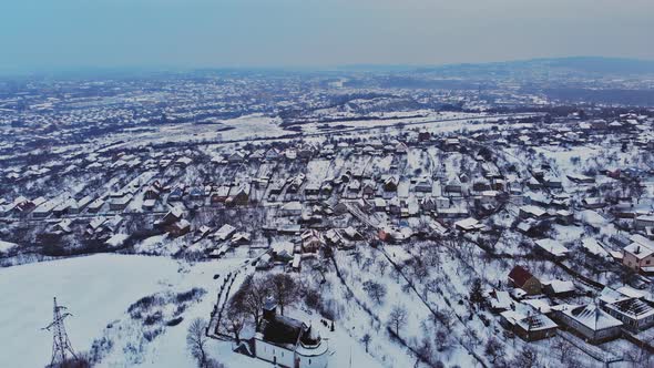 Overhead aerial view of residential houses and village houses covered in snow in winter time