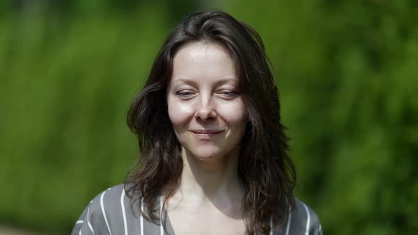 Portrait of Charming Middle Aged Woman in Park in Daytime Pretty Lady is Smiling