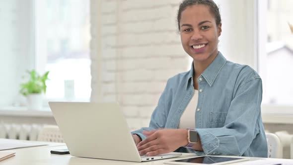 Young African Woman Working and Showing Thumbs Up