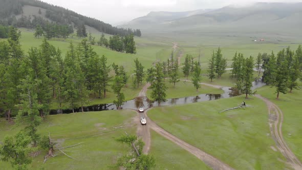 Two 4X4 Suv Cars Passing by Waters of River in Forest