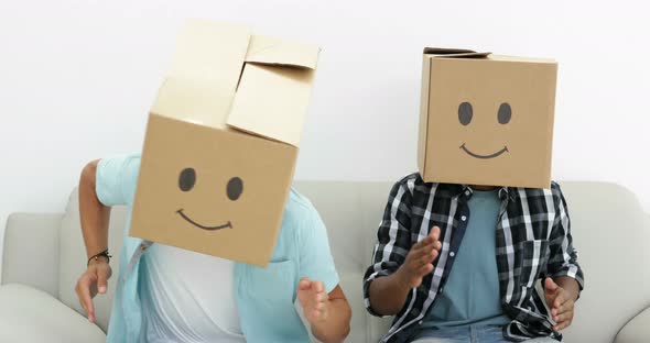 Silly employees with boxes on their heads doing the robot