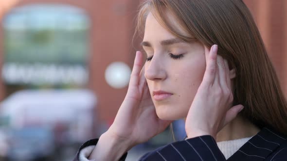 Tired Woman with Headache Trying to Relax