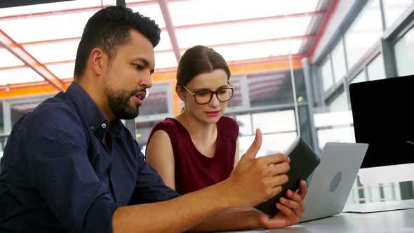 Business executives using digital tablet and laptop