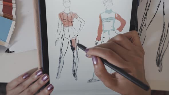 Top Down of Female Designer Drawing Fashion Sketch