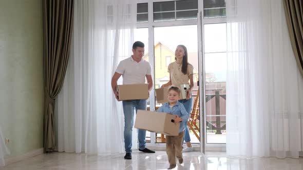 Happy Child Runs Into Large New House Holding Big Craft Box