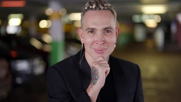 Closeup Portrait of a Young Handsome Man with Tattoos Standing on the Street in Winter in a Business