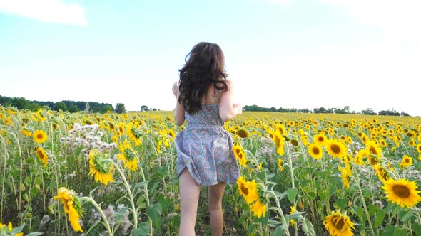 Close Up of Pretty Girl Running Through Sunflower Field