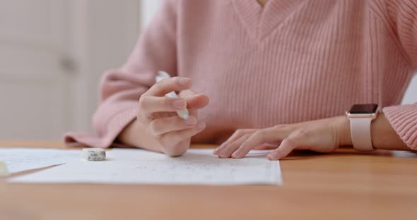 Woman write on the paper for study at home