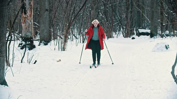 A Young Blonde Woman Walking on Ski in the Woods