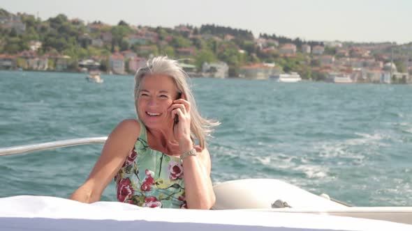 Senior female calling on yacht