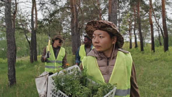 Diverse Farmers Carrying Seedlings