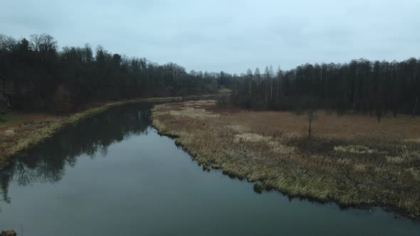 The river among the city park. Late autumn, cloudy.