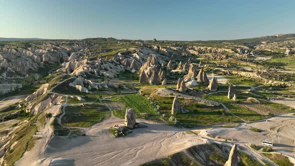 4K Aerial view of Goreme. Colorful hot air balloons fly over the valleys.