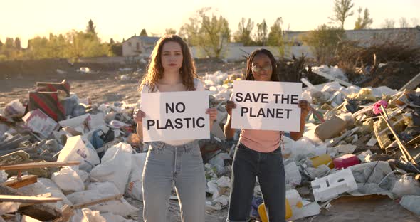 Ecology Activists Holding Signs Agains Pollution at Trash Pill