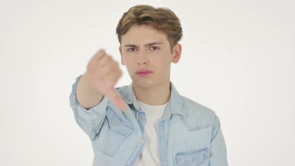 Thumbs Down Gesture By Young Man on White Background