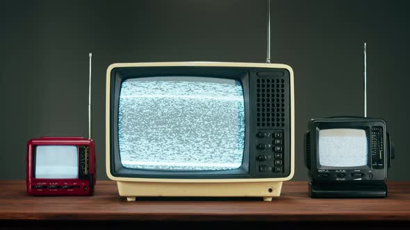 Old Televisions with Grey Interference Screen on Black Background