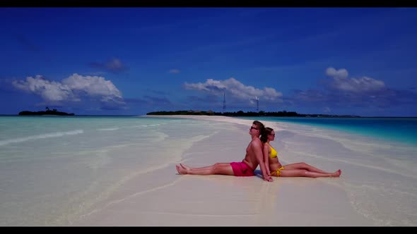 Two lovers engaged on paradise sea view beach wildlife by blue water with white sand background of t