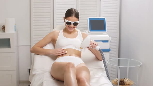 Attractive Woman Doing Laser Epilation Procedure By Herself.