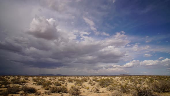 Mojave Desert storm forming with thick clouds over barren landscape