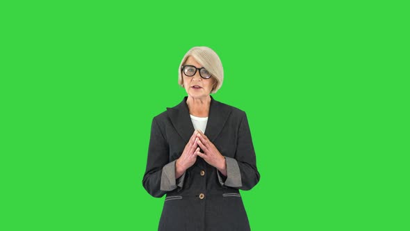 Strict Attractive Senior Woman Talking To Camera on a Green Screen Chroma Key