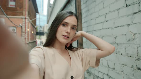 Playful Girl Taking Selfie Outdoors Posing and Looking at Camera Making Funny Faces Having Fun Alone