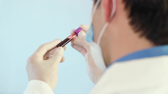 Doctor Examine Blood Tube in Laboratory