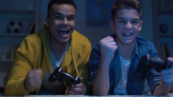 Emotional Multiracial Male Friends Winning Computer Game, Leisure Activity