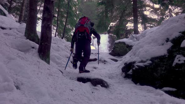 Mountaineer Man Climbing A Snowy Slope