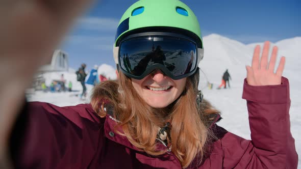 Young Woman in Ski Snowboard Gear Makes Selfie
