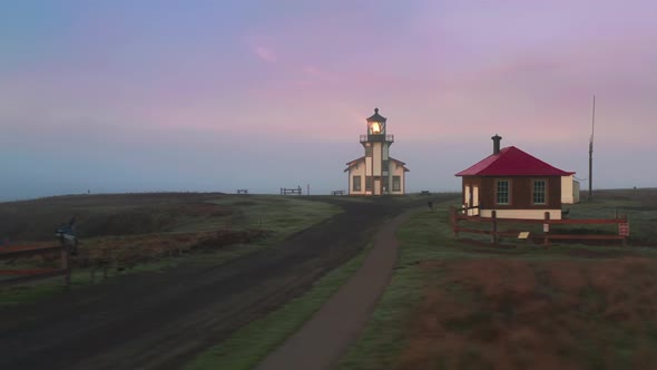 Scenic Aerial View Lighthouse with Pink Purple Clouds Colored By Sunrise Light