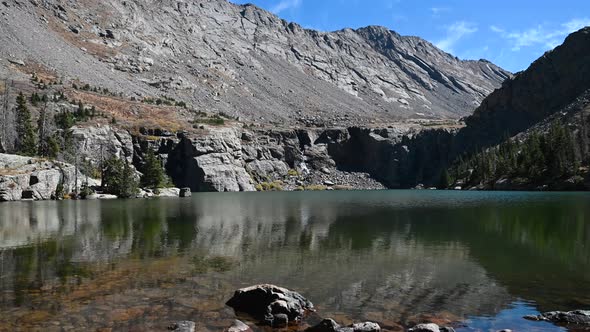 Snowmelt waterfall running into Willow Lake with Colorado mountain views, static