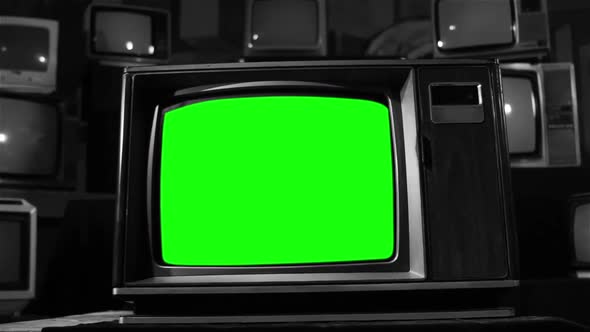 Old Television with Green Screen Among Vintage TVs in Black-and-White