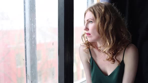 Beautiful woman looking in window