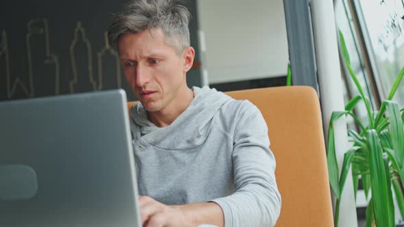 Sick and Tired Looking Man Using Laptop