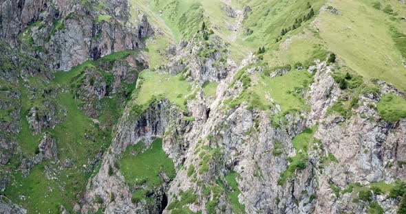 Top View of Steep Mountain Cliffs and an Ice Cave