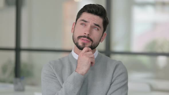 Portrait of Pensive Young Man Thinking