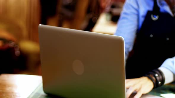 Craftswoman using laptop