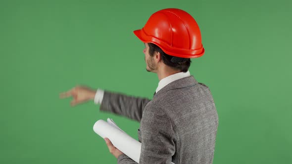 Rear View Shot of a Male Engineer Working on Transparent Futuristic Screen