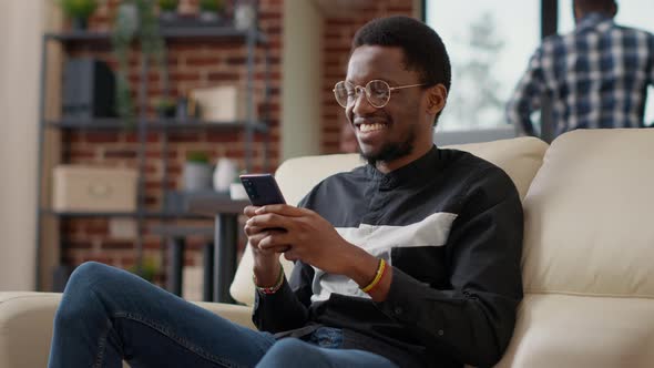 African American Man Browsing Internet on Smartphone