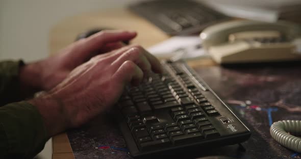 Male hands typing on a computer keyboard and touching the mouse