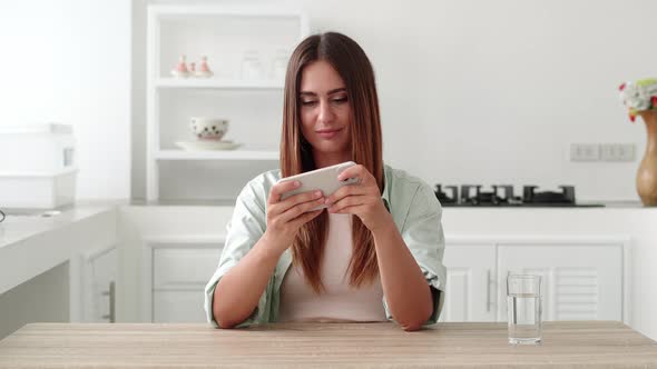 Young Woman Having Fun Playing Phone on Break