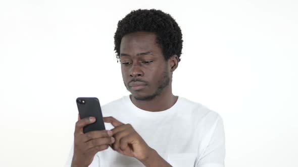 African Man Browsing Smartphone White Background