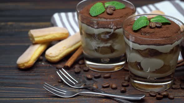 Two Portions Classic Tiramisu Dessert in a Glass on Wooden Background