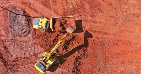 Excavator Working at Backhoe Digs Ground for Laying Concrete Pipes on Construction Site on