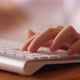 Child fingers typing on the white computer keyboard - VideoHive Item for Sale
