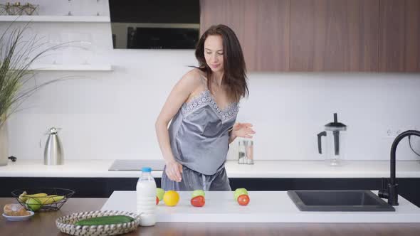 Happy Pregnant Young Woman Dancing in Kitchen in Slow Motion