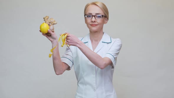 Nutritionist Doctor Healthy Lifestyle Concept - Holding Ginger Root, Lemon Fruit and Measuring Tape